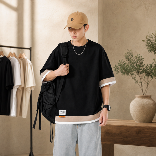 Black oversized t-shirt with contrast hem worn in a warm neutral interior