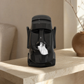 Tissue box stone figure in black on a travertine side table