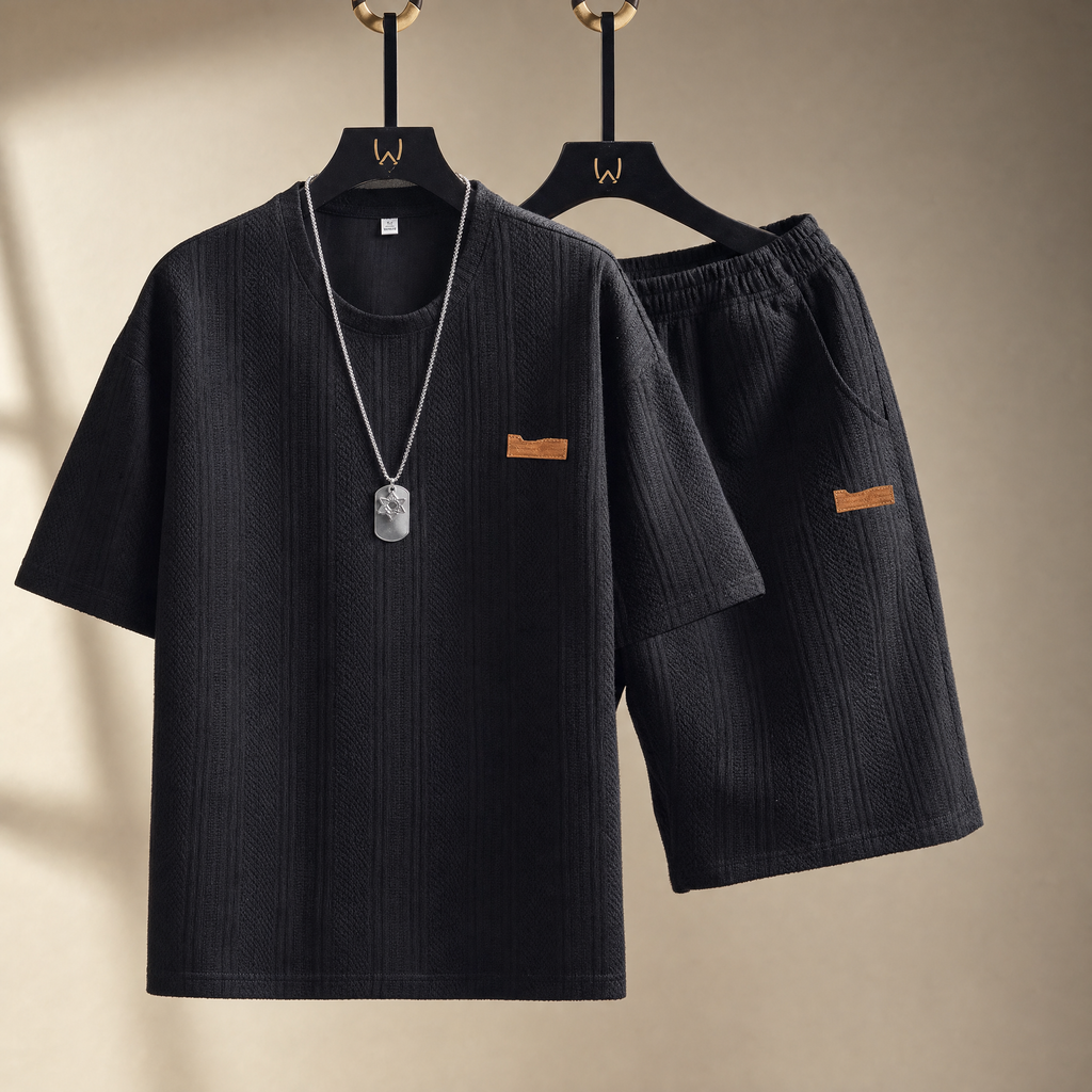 Men's sports two-piece set in black on a warm studio backdrop